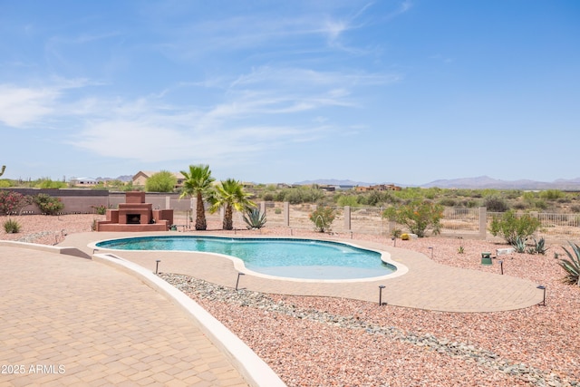 16246 E Gamble Ln, Scottsdale, AZ 85262 - view of pool with exterior fireplace, a mountain view, and a fenced backyard