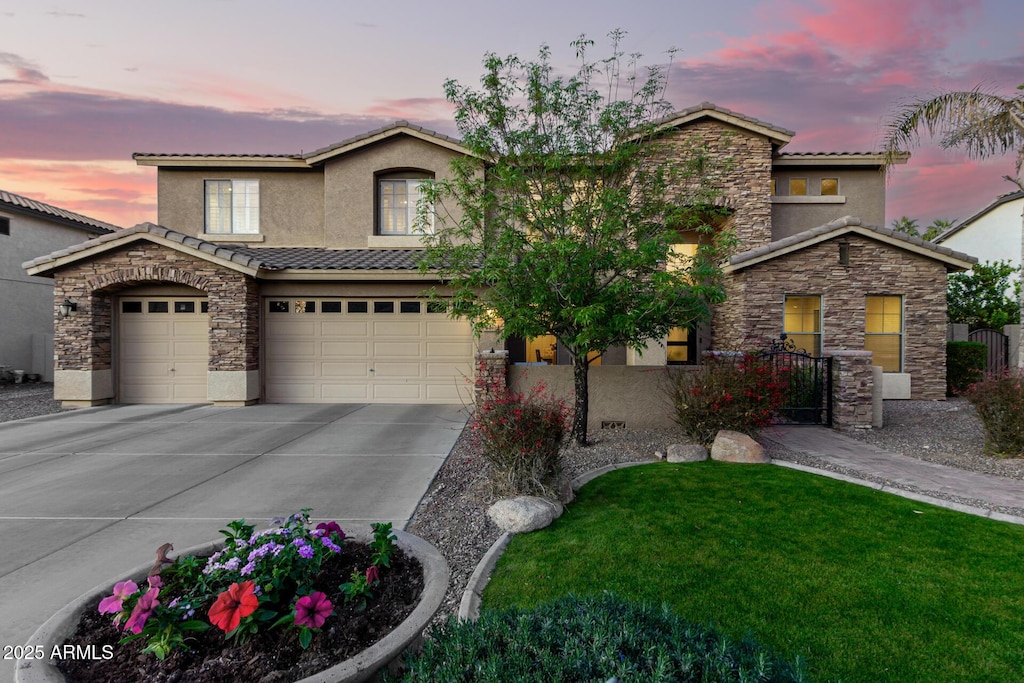 view of front of house with a yard and a garage