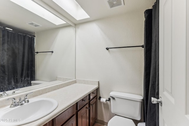 full bath with visible vents, vanity, and toilet