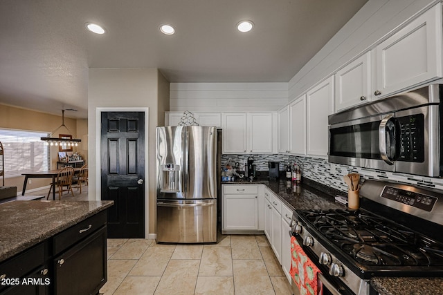 6640 W Honeysuckle Dr, Phoenix, AZ 85083 - kitchen featuring appliances with stainless steel finishes, dark stone counters, decorative backsplash, and white cabinets