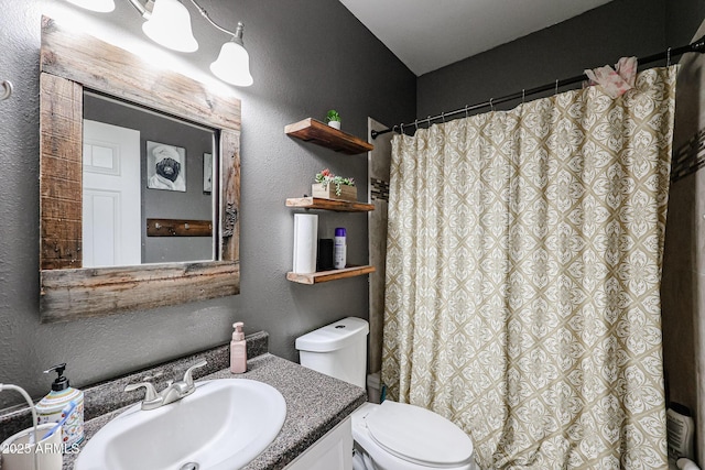 6640 W Honeysuckle Dr, Phoenix, AZ 85083 - bathroom featuring a shower with curtain, vanity, and toilet