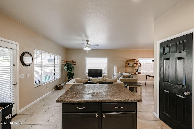 6640 W Honeysuckle Dr, Phoenix, AZ 85083 - kitchen with light tile patterned flooring, ceiling fan, and a kitchen island