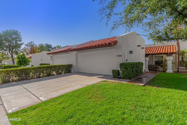 view of home's exterior featuring a garage and a lawn