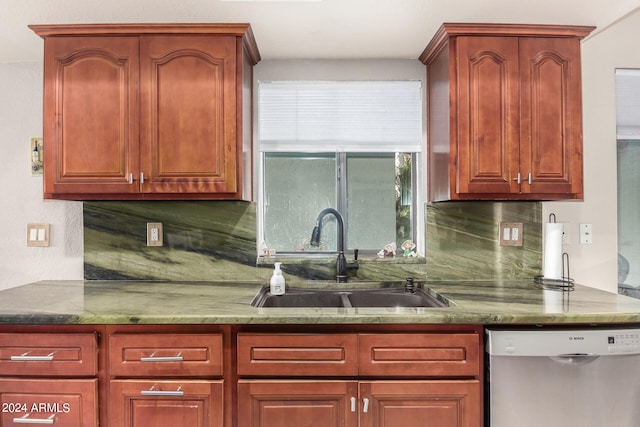 kitchen featuring tasteful backsplash, stainless steel dishwasher, and sink