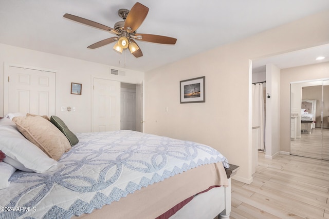 bedroom with light hardwood / wood-style floors and ceiling fan