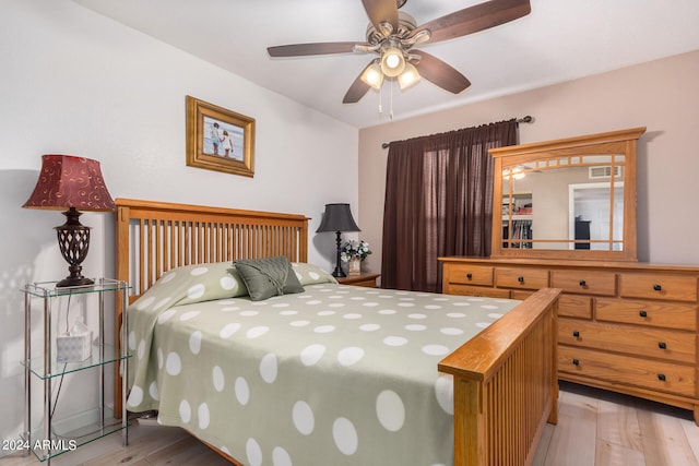 bedroom with light hardwood / wood-style floors and ceiling fan