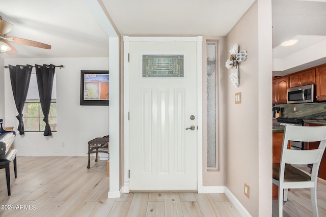 entryway featuring light wood-type flooring and ceiling fan