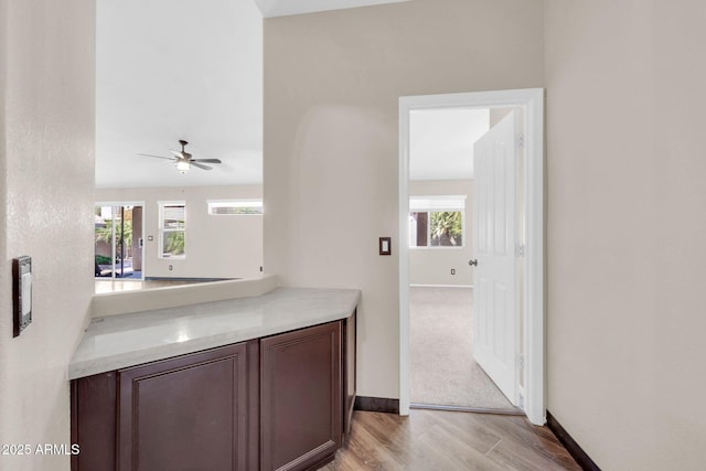 bar featuring light wood finished floors and baseboards