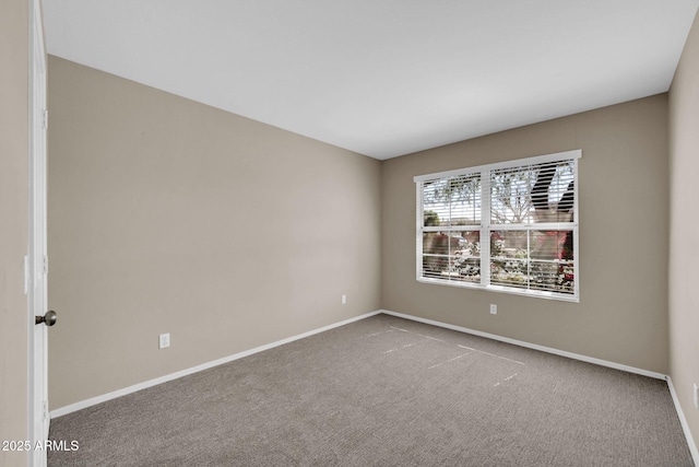 carpeted spare room with baseboards