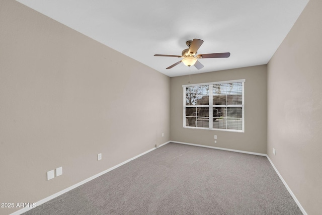 spare room featuring ceiling fan, baseboards, and carpet flooring