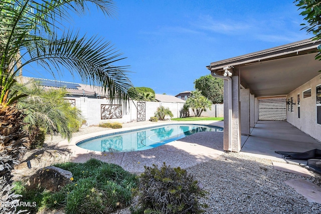 view of swimming pool featuring a patio, a fenced backyard, and a fenced in pool