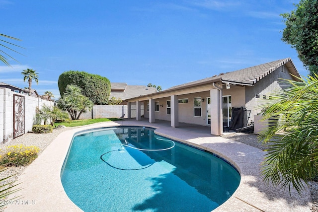 view of pool with a fenced in pool, a fenced backyard, and a patio