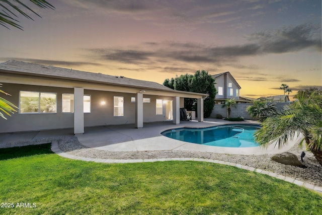 view of swimming pool featuring a fenced in pool, a patio, fence, and a lawn