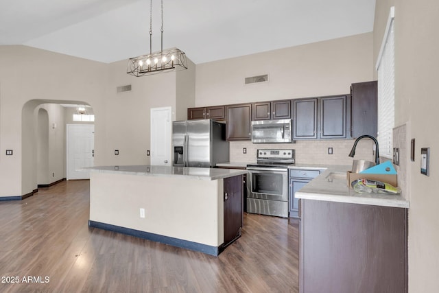 kitchen with light countertops, appliances with stainless steel finishes, a sink, and visible vents