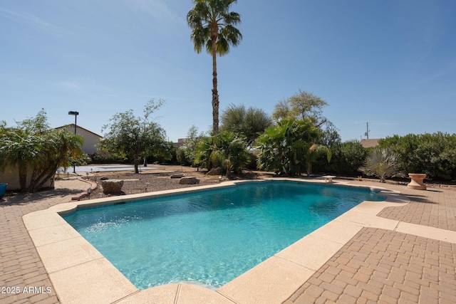 outdoor pool with a patio area