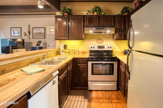 4575 Resort Loop Unit 6, Pinetop, AZ 85935 - kitchen featuring white appliances, range hood, a sink, dark wood finished floors, and dark brown cabinets