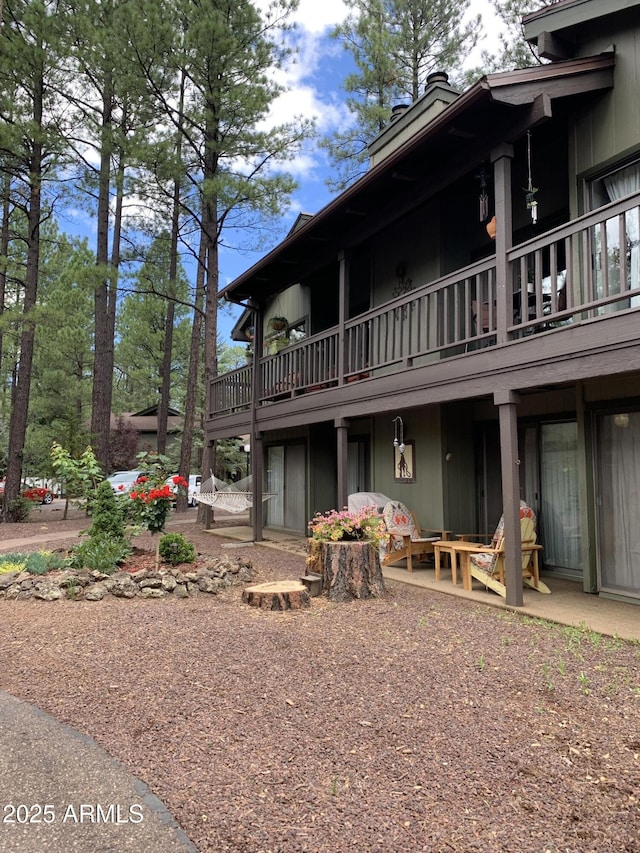 4575 Resort Loop Unit 6, Pinetop, AZ 85935 - back of house featuring a chimney, a balcony, and a patio
