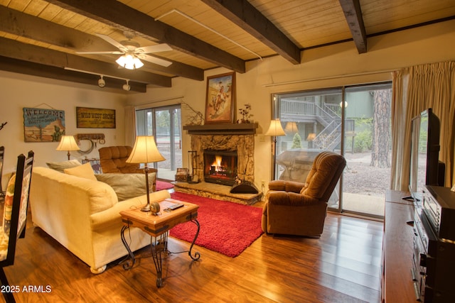 4575 Resort Loop Unit 6, Pinetop, AZ 85935 - living area with wood finished floors, wood ceiling, a stone fireplace, beamed ceiling, and a ceiling fan