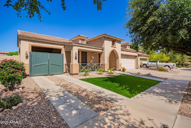 800 W Sycamore Ct, Litchfield Park, AZ 85340 - mediterranean / spanish-style house with a porch, stucco siding, a gate, fence private yard, and a garage