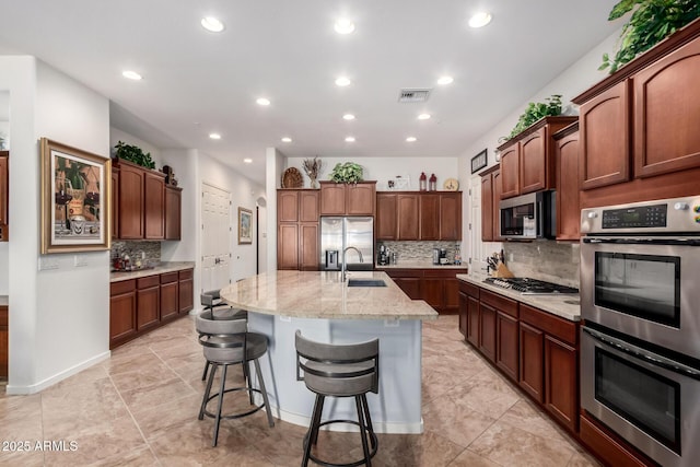800 W Sycamore Ct, Litchfield Park, AZ 85340 - kitchen with recessed lighting, a sink, tasteful backsplash, visible vents, and appliances with stainless steel finishes
