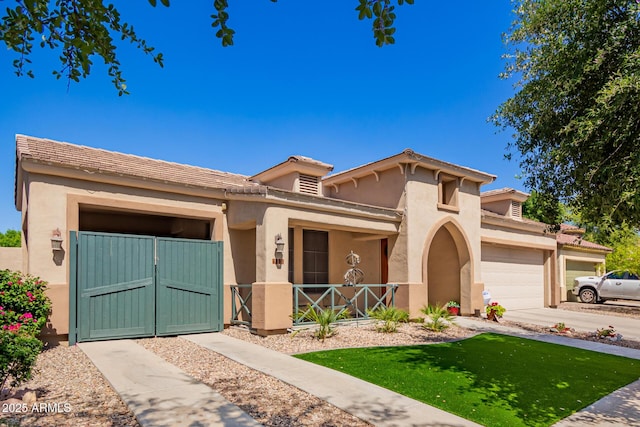 800 W Sycamore Ct, Litchfield Park, AZ 85340 - mediterranean / spanish-style house featuring a garage, a porch, a gate, and stucco siding