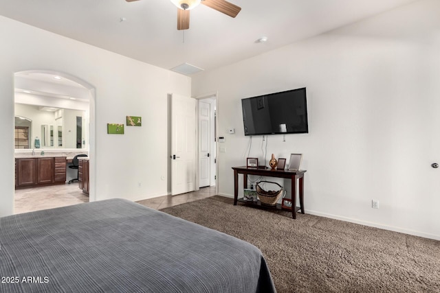 800 W Sycamore Ct, Litchfield Park, AZ 85340 - bedroom featuring baseboards, arched walkways, light carpet, and connected bathroom