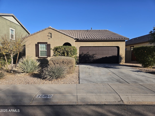 36850 W Nola Way, Maricopa, AZ 85138 - mediterranean / spanish-style home with a garage