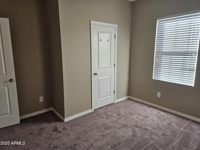 unfurnished bedroom featuring light carpet