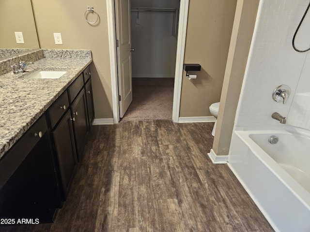 full bathroom with wood-type flooring, bathing tub / shower combination, toilet, and vanity