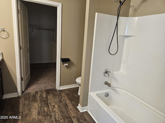 full bathroom featuring hardwood / wood-style flooring, shower / tub combination, vanity, and toilet