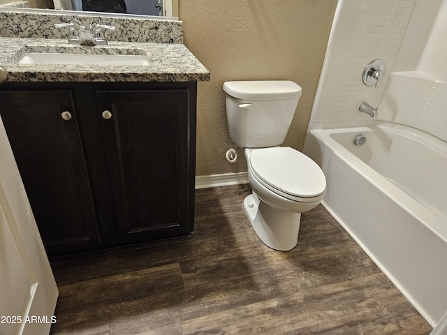 full bathroom featuring wood-type flooring, toilet, shower / washtub combination, and vanity