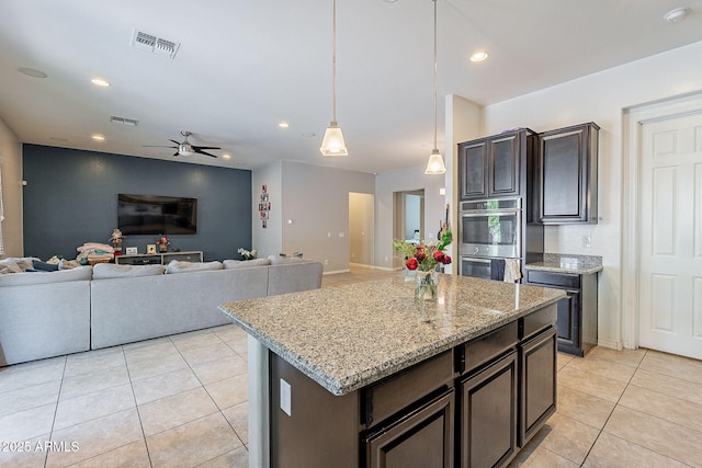 kitchen featuring double oven, visible vents, ceiling fan, and light tile patterned floors
