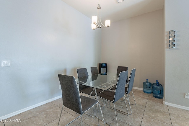 dining space featuring light tile patterned flooring, visible vents, baseboards, and an inviting chandelier