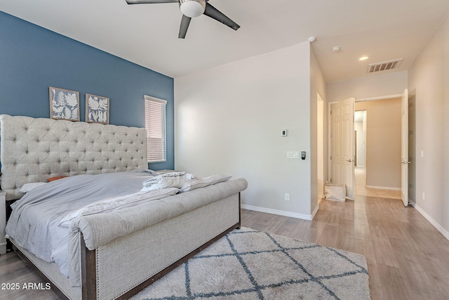 bedroom with baseboards, visible vents, wood finished floors, and ceiling fan