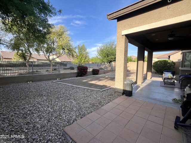 view of patio / terrace with a ceiling fan and fence private yard