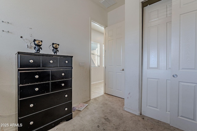 bedroom with baseboards, visible vents, and carpet