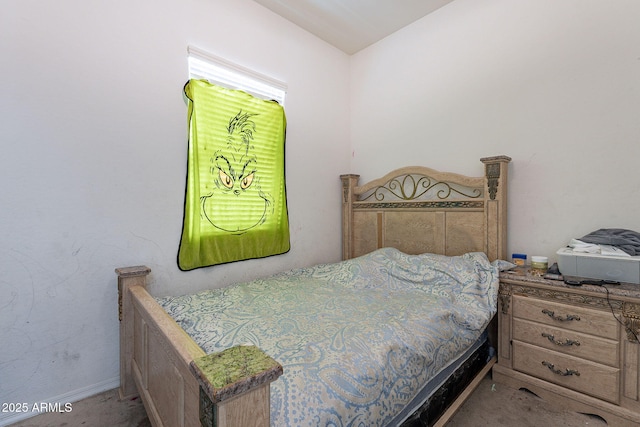 bedroom with baseboards and carpet