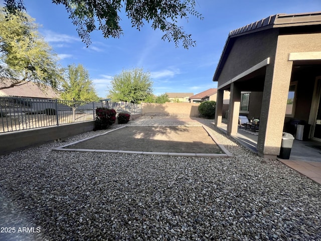 view of parking / parking lot with a fenced backyard