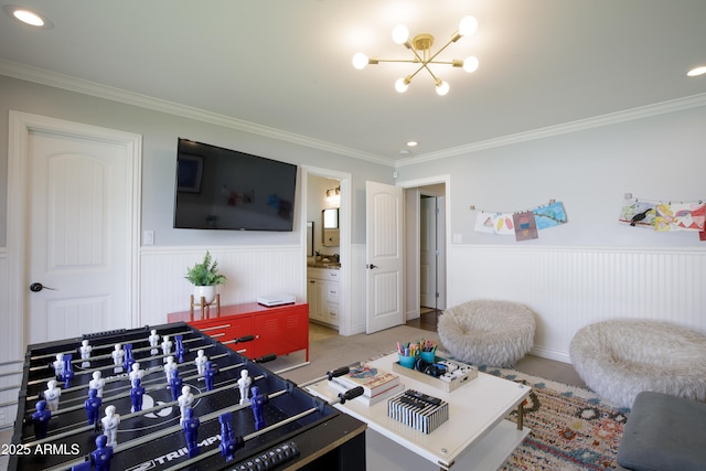 game room featuring recessed lighting, crown molding, a wainscoted wall, and an inviting chandelier