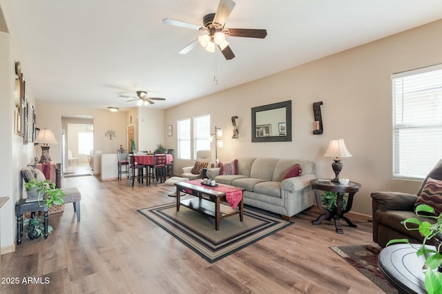 living room featuring hardwood / wood-style floors and ceiling fan