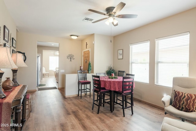 dining space featuring ceiling fan and light wood-type flooring