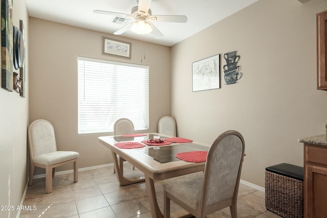 dining area featuring light tile patterned floors and ceiling fan