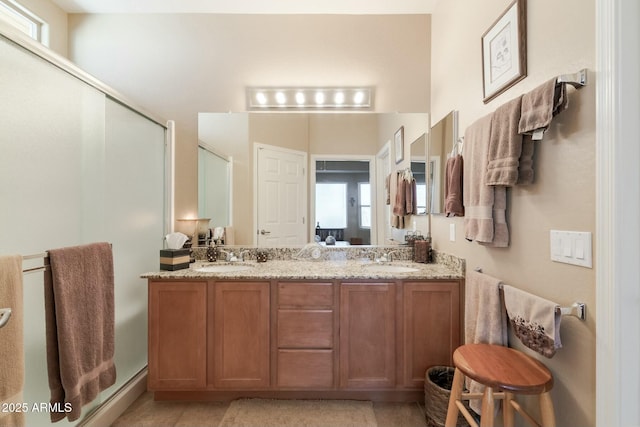 bathroom featuring vanity and a shower with shower door