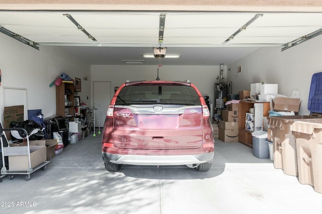 garage with a garage door opener and water heater