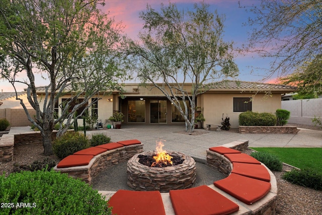 11193 N 121st Way, Scottsdale, AZ 85259 - view of front of property with a fire pit, stucco siding, and a patio area