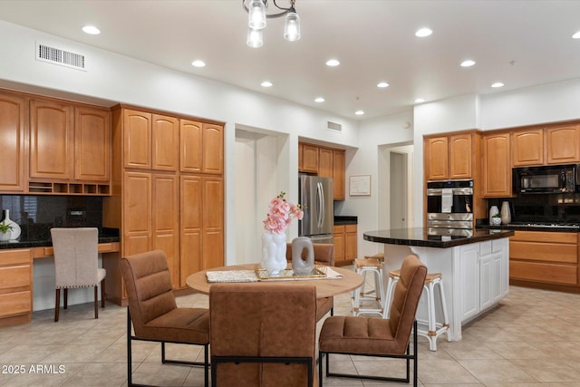11193 N 121st Way, Scottsdale, AZ 85259 - kitchen with stainless steel appliances, decorative backsplash, light tile patterned floors, a center island, and recessed lighting