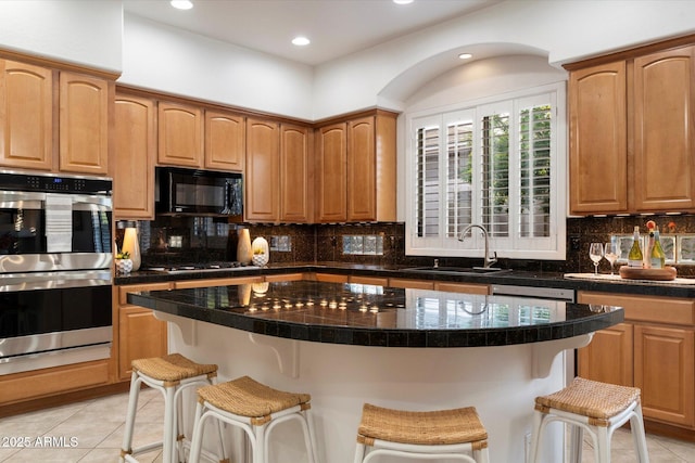 11193 N 121st Way, Scottsdale, AZ 85259 - kitchen featuring appliances with stainless steel finishes, light tile patterned floors, a breakfast bar area, tasteful backsplash, and recessed lighting