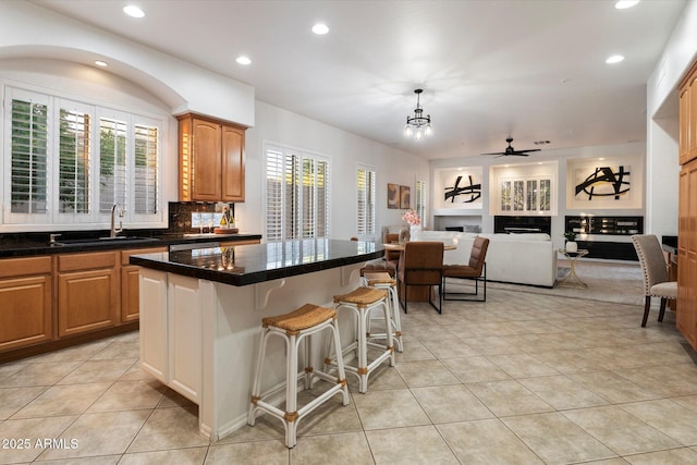 11193 N 121st Way, Scottsdale, AZ 85259 - kitchen featuring recessed lighting, light tile patterned floors, a breakfast bar, open floor plan, and a center island