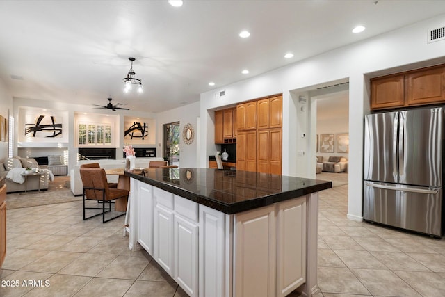 11193 N 121st Way, Scottsdale, AZ 85259 - kitchen with freestanding refrigerator, a fireplace, tile counters, light tile patterned flooring, and open floor plan
