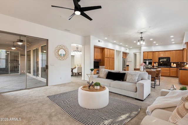 11193 N 121st Way, Scottsdale, AZ 85259 - living room featuring a chandelier, a ceiling fan, light colored carpet, and recessed lighting